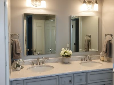 After: updated bathroom with modern vanity, new lighting, fresh accessories, and improved storage