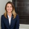 Professional headshot of satisfied bathroom renovation client Sarah M. in business attire